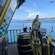 View from the deck of a pirate ship with a wheel and an eagle statue overlooking the sea